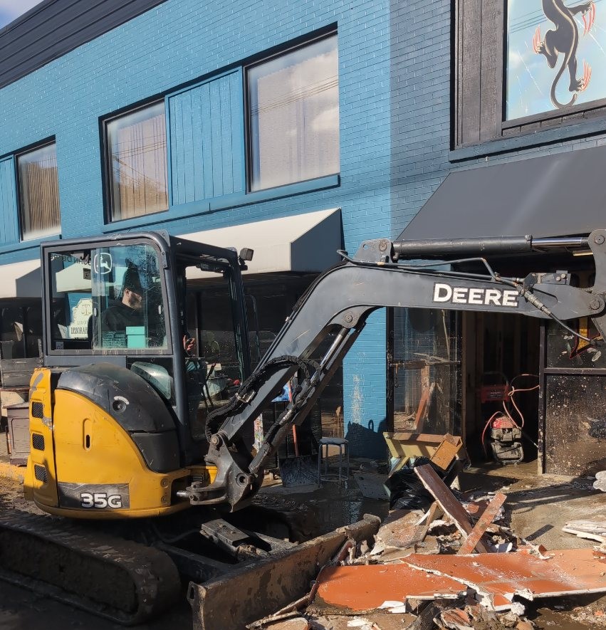 East76 excavator clearing flood debris