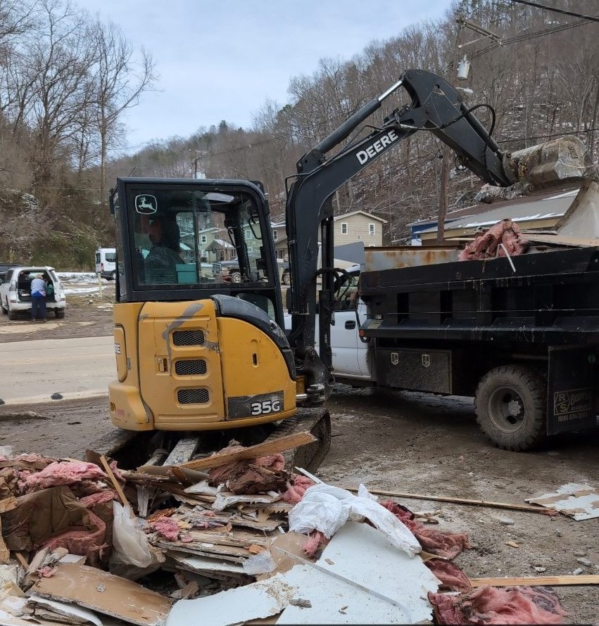 East76 excavator loading flood debris in downtown Hazard
